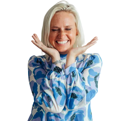 Nikki Anderson smiling with her hands under her chin